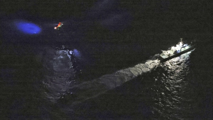 A Japan's coast guard vessel and a helicopter conduct search and rescue operation around the site where a U.S. military Osprey aircraft was believed to crash in the sea off Yakushima Island, southern Japan. Photo / Kyodo News via AP