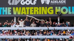 Spectators hold up a beer snake on the 12th hole during LIV Adelaide at The Grange Golf Club on April 26. Photo / getty