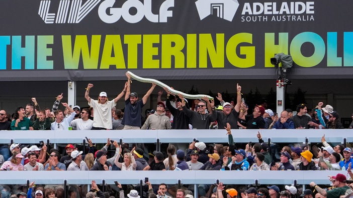 Spectators hold up a beer snake on the 12th hole during LIV Adelaide at The Grange Golf Club on April 26. Photo / getty