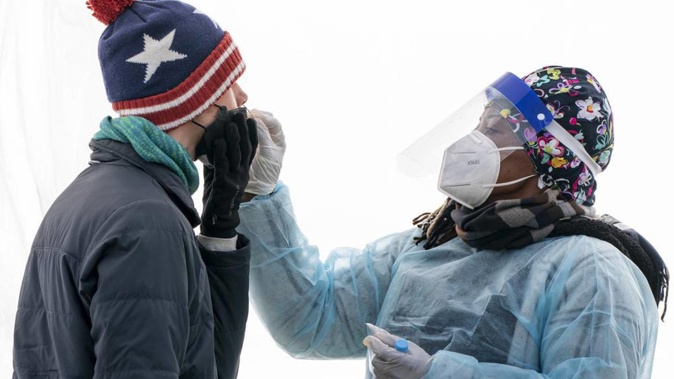 A man is swabbed for COVID-19 at a walk-up testing site at Farragut Square on Dec. 23, 2021, just blocks from the White House in Washington. Photo / AP