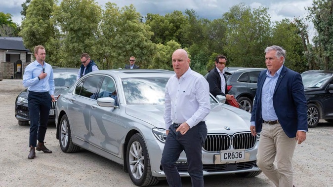 Christopher Luxon arriving at a Puketapu farm with Minister for Emergency Management and Recovery Mark Mitchell on Sunday to announce $63m of silt and debris removal funding in cyclone-hit areas. Photo / Connull Lang
