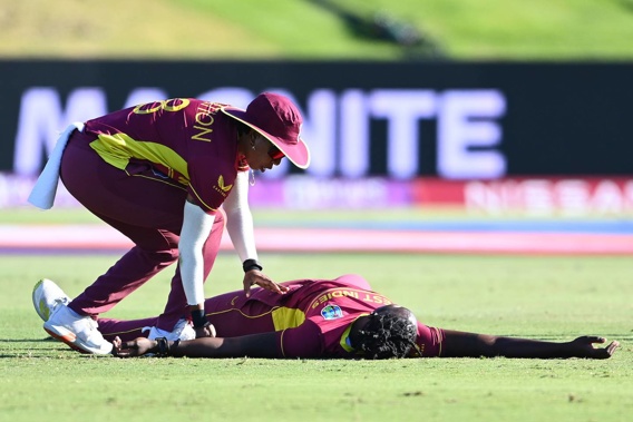 Shamilia Connell of the West Indies is assisted by teammate Chedean Nation after collapsing during their match against Bangladesh. (Photo / Getty)