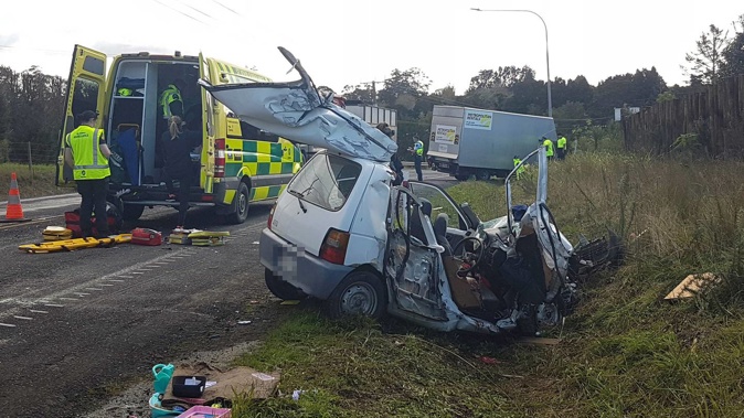 Firefighters had to remove the hatchback's roof and doors to free the driver. Photo / Peter de Graaf