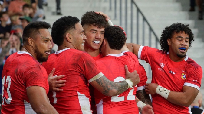 Tonga's Kyren Taumoefolau, middle, celebrates after scoring a try against Romania. Photo / AP