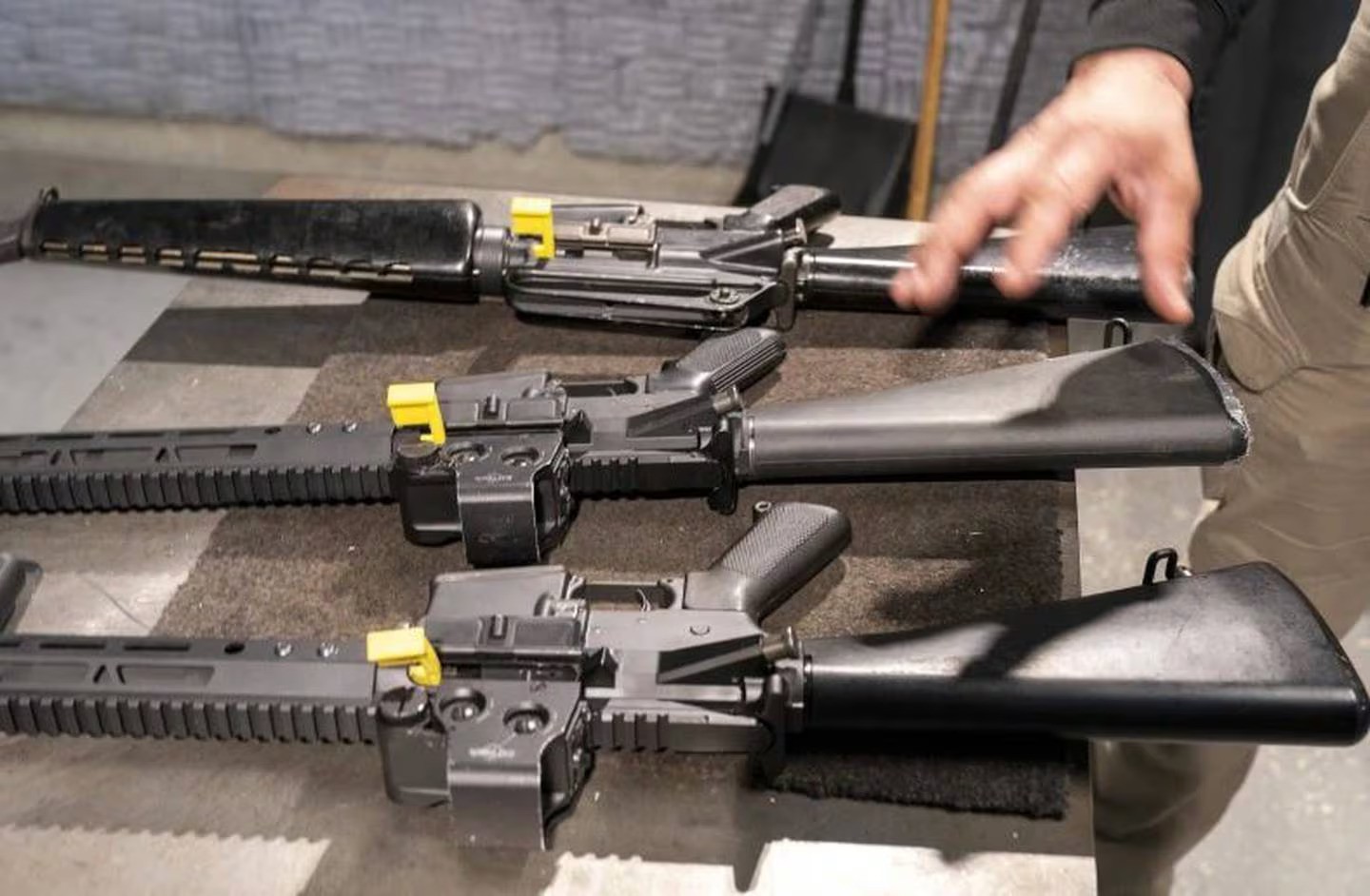 A row of AR-15 style rifles, one with a conversion device installed making it fully automatic, and one a fully automatic M-16 machine gun, at the Bureau of Alcohol, Tobacco, Firearms, and Explosives (ATF), National Services Centre. Photo / AP