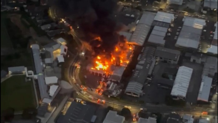A large plume of black smoke was seen pouring out of a building in Auckland's Wairau Valley. Photo / Inflite Limited Helicopters