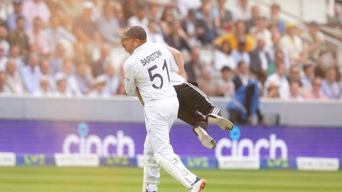 England's Johnny Bairstow carries a Just Stop Oil protester off the pitch, Photo / AP