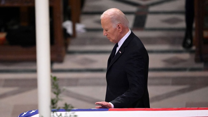 US President Joe Biden touches the casket after delivering the eulogy at the State Funeral Service for former US President Jimmy Carter at the Washington National Cathedral in Washington, DC. Photo / AFP