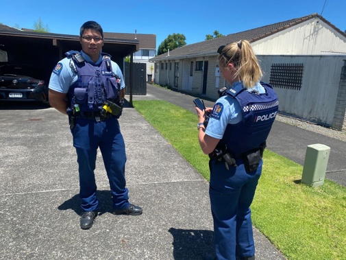 Police canvassing the street of the man accused of murdering a child and bringing their body to the Manukau Police Station. Photo / Raphael Franks
