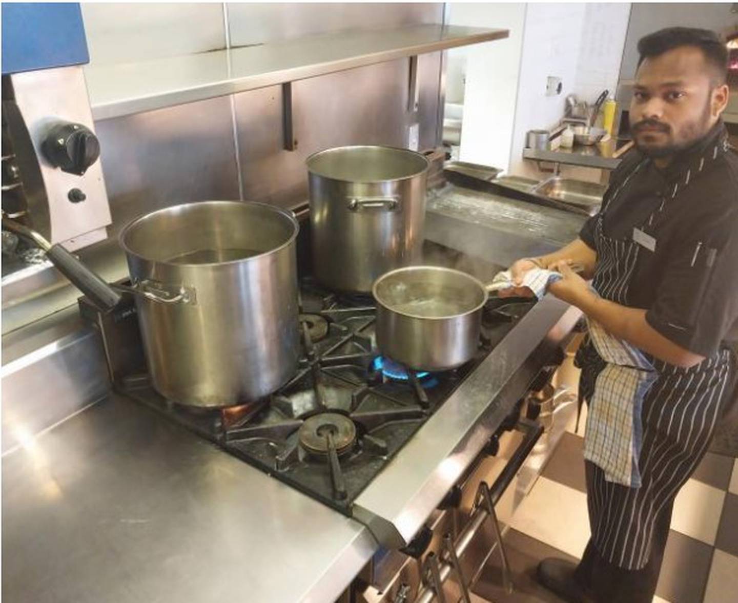 Chef Kshitij Zungare tends to pots of water being boiled for guests and staff of Hotel St Moritz, in Queenstown. Photo / Matt Porter