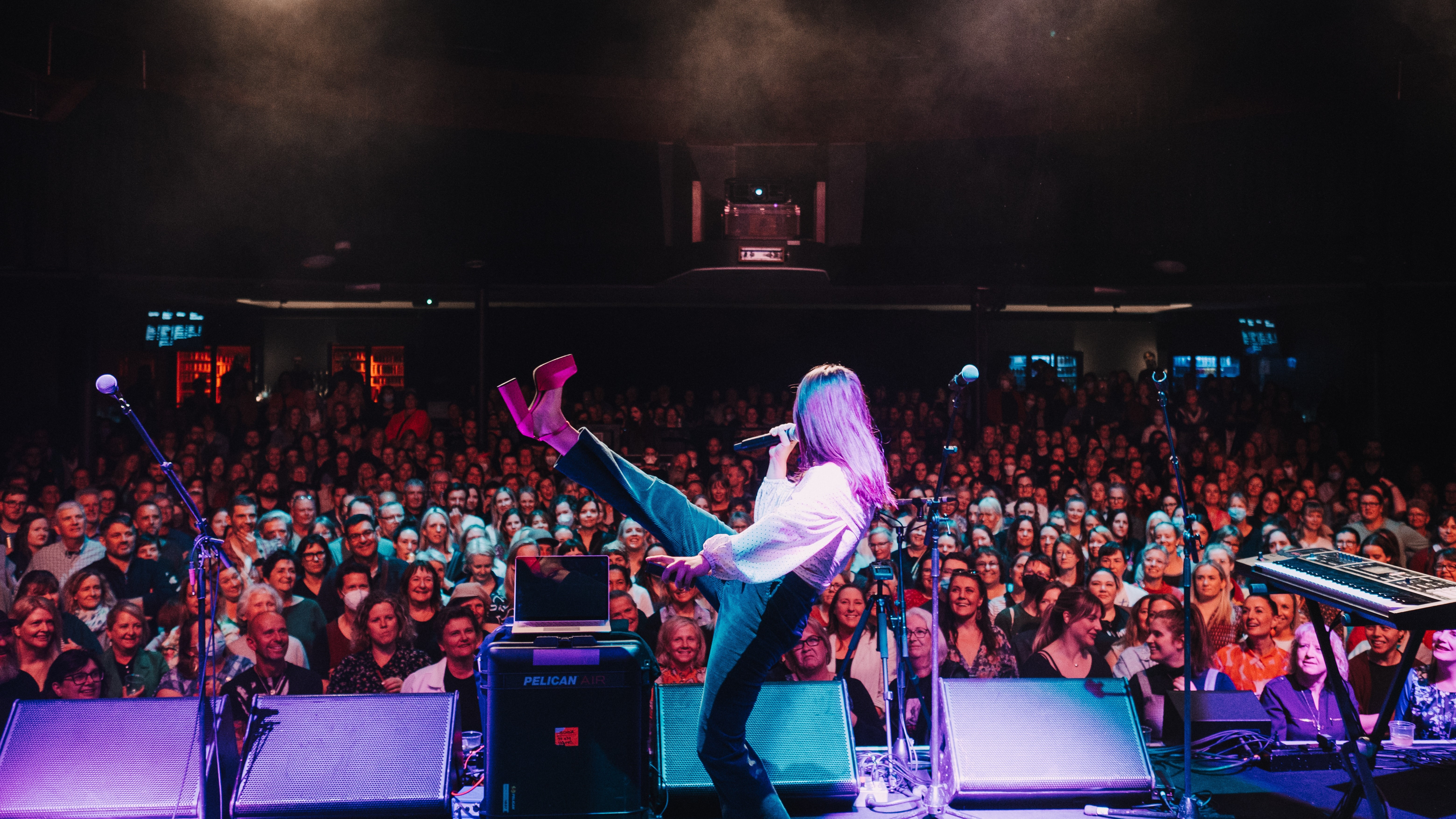 Pub Choir's Astrid Jorgensen in 2022, leading an audience in Hobart, Australia. Photo / File