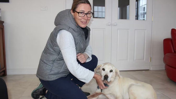 Chris Alty with family dog Sydney who is back at home after being missing for 60 days. Photo / David Haxton