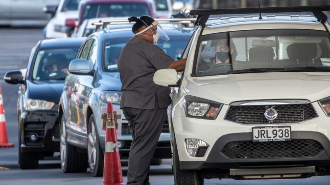 Cars queue for Covid-19 testing at Westgate as New Zealand's Omicron outbreak surges. Photo / Michael Craig