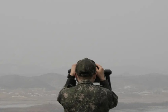 A South Korean army soldier watches the North Korea side from the Unification Observation Post in Paju, South Korea, near the border with North Korea, Friday, March 24, 2023. North Korea said Friday its cruise missile launches this week were part of nuclear attack simulations that also involved a detonation by a purported underwater drone as leader Kim Jong Un vowed to make his rivals "plunge into despair." (AP Photo/Ahn Young-joon)