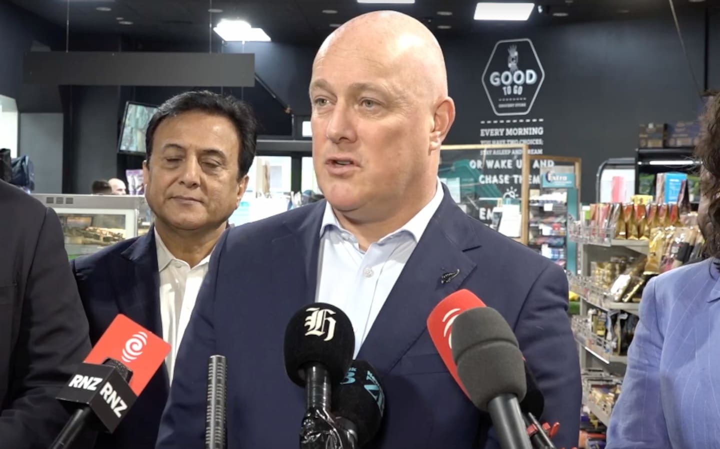 Luxon's security detail whisked him out of a press conference on law and order in Auckland. Photo / Supplied