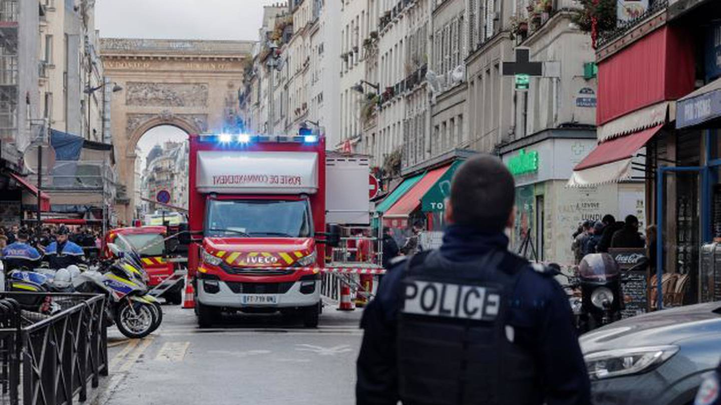 A police officer stands next to the cordoned-off area where the shooting took place in Paris on Friday. Photo / AP