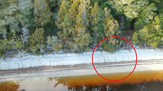 A passing helicopter spotted this 'HELP' message written in the sand next to Lake Ahaura, West Coast. eliciting concern from police. Photo / Supplied