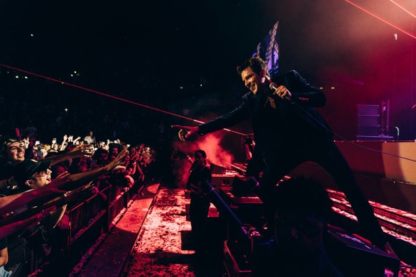 In this photo from the Killers' Spark Arena concert, Taylor Johnston can be seen on the left reaching towards the stage. Photo / Chris Phelps.