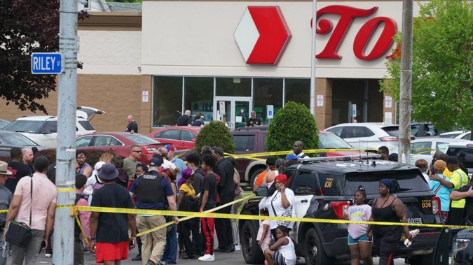 People gather outside a supermarket where several people were killed in a shooting in Buffalo, New York. Photo / AP