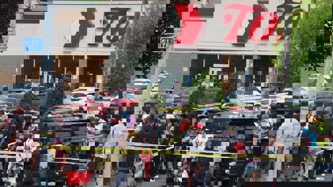 People gather outside a supermarket where several people were killed in a shooting in Buffalo, New York. Photo / AP