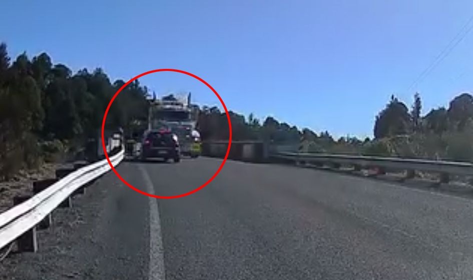 Dashcam footage shows the moment a hatchback overtaking on a bridge nearly crashed head-on into a truck. Photo / Supplied