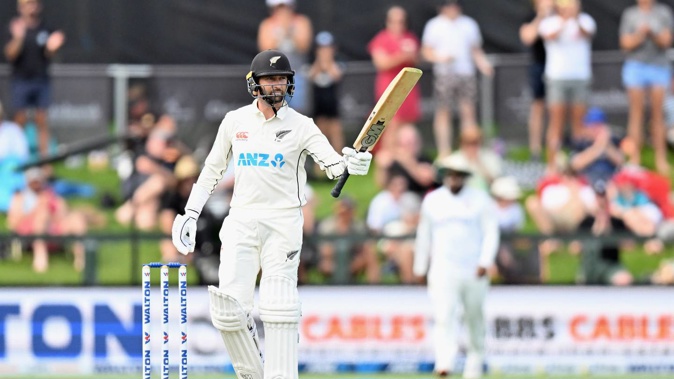 Devon Conway raises his bat after reaching 50 on day one of the second test. Photo / Getty