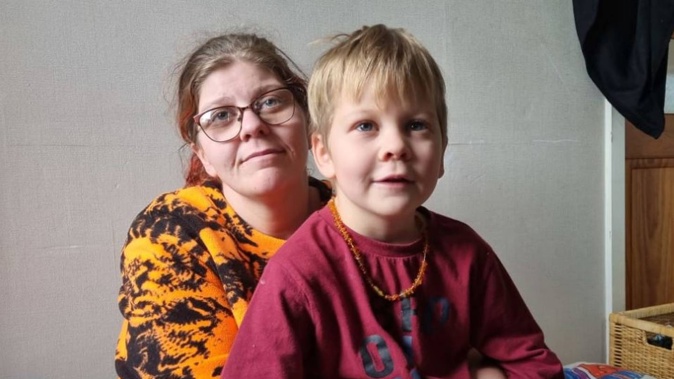 Bronwyn McCown and five-year-old Caleb. She has moved her three children into the living room. Photo / RNZ / Robin Martin