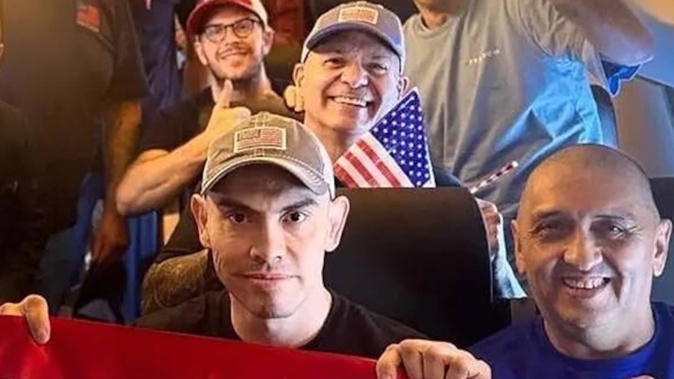 A US State Department photo shows Americans and US residents imprisoned in Venezuela being returned to the US. Dahud Hanid Ortiz is at the centre, third from the right, holding a small flag and wearing a grey cap. Photo US State Department