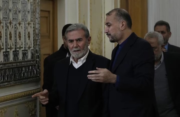 The leader of the Palestinian Islamic Jihad group Ziad Nakhaleh, left, and the Iranian Foreign Minister Hossein Amirabdollahian, arrive for signing a guest book by Nakhaleh, after their meeting in Tehran. Photo / AP