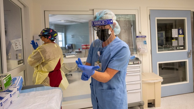Nurses Assistant Vanessa Gutierrez, left, and Jamie McDonough, RN, enter a Covid-19 patient room at St. Joseph Hospital in Orange, California, on July 21. Photo / Getty Images