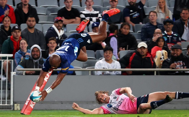 Mark Telea applies an acrobatic finish to his try against the Rebels. (Photo / Getty)