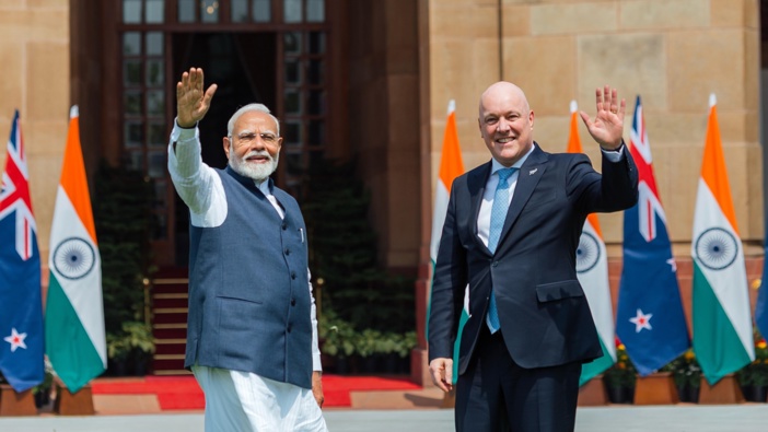 Prime Minister Christopher Luxon and India PM Narendra Modi wave at media ahead of their bilateral meeting. Photo / Interest.co.nz