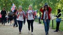 Royal fans walk alongside the Mall leading to Buckingham Palace in London. Photo / AP