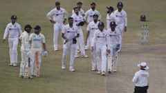 Rachin Ravindra and Ajaz Patel are delivered the news that play had ended as India react with dejection. (Photo / AP)