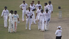 Rachin Ravindra and Ajaz Patel are delivered the news that play had ended as India react with dejection. (Photo / AP)