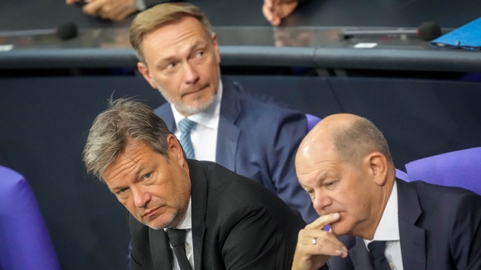 Christian Lindner (M, FDP), Federal Minister of Finance, Robert Habeck (l, Alliance 90/The Greens), Federal Minister for Economic Affairs and Climate Protection, and Federal Chancellor Olaf Scholz (SPD) take part in the session of the Bundestag. (Photo by Kay Nietfeld/picture alliance via Getty Images)
