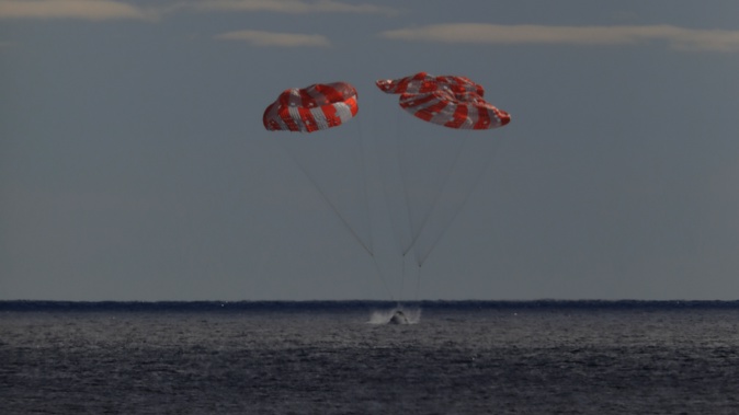 In this photo provided by NASA the Orion spacecraft for the Artemis I mission splashes down in the Pacific Ocean after a 25.5 day mission to the Moon, Sunday, Dec. 11, 2022. (NASA via AP)