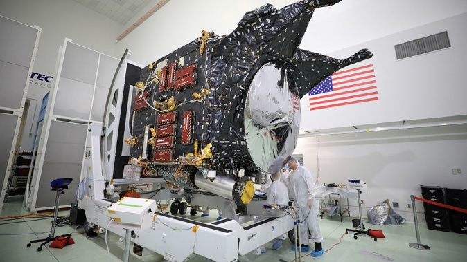 A team prepares NASA's Psyche spacecraft for launch inside the Astrotech Space Operations Facility near the agency's Kennedy Space Center in Florida in December 2022. Ben Smegelsky/NASA