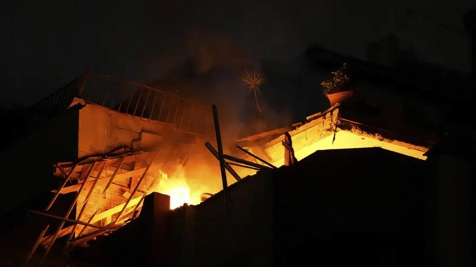 Fire burns at an apartment of an Islamic Jihad commander for northern Gaza, following Israeli airstrikes in Gaza City. Photo / AP
