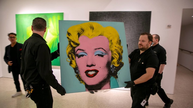 The 1964 painting Shot Sage Blue Marilyn by Andy Warhol is carried in Christie's showroom in New York City. (Photo / AP)