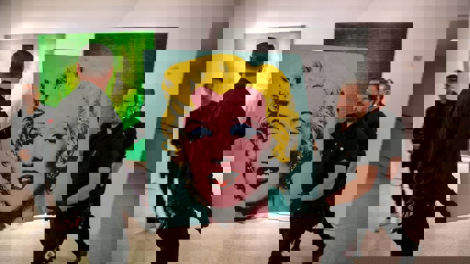 The 1964 painting Shot Sage Blue Marilyn by Andy Warhol is carried in Christie's showroom in New York City. (Photo / AP)