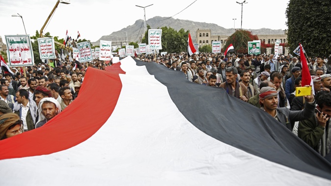 Houthi supporters chant slogans holding signs reading "Death to America, Death to Israel", as they attend a rally marking eight years for a Saudi-led coalition, Friday, March 26, 2023, in Sanaa, Yemen. Photo / AP