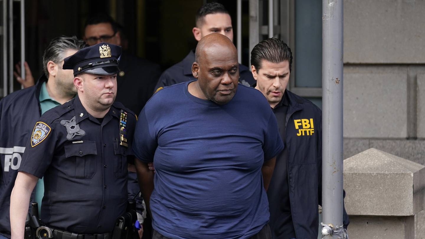 Law enforcement officials lead subway shooting suspect Frank James away from a police station in New York on April 13, 2022. Photo / AP