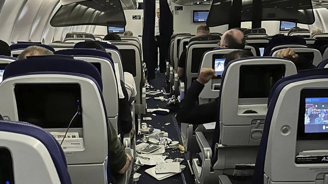 Food trays and other stuff are scattered inside the cabin as Lufthansa Flight 469 from Austin, Texas, headed to Frankfurt, Germany. Photo / Ecaterina Fadhel, AP