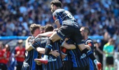 Auckland FC players celebrate their opening goal, before Brisbane came back. Photosport.