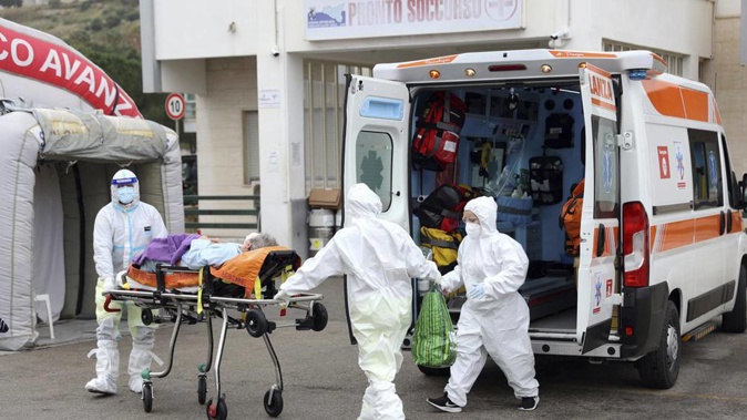 An ambulance for Covid emergency unloads a patient at the Cervello hospital in Palermo, Sicily, where tented field hospitals have been set up. Photo / AP