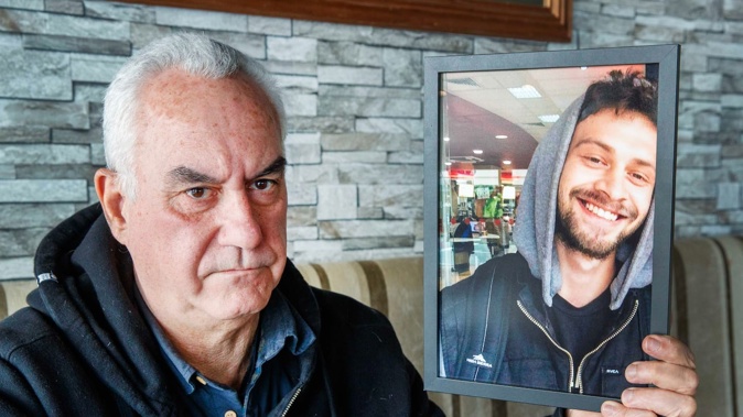 Roger Calkin with a photo of his late son, Sandy Calkin. Roger is hopeful Wellington City Council will install permanent balustrades on the waterfront as the coroner has recommended. Photo / Mark Mitchell