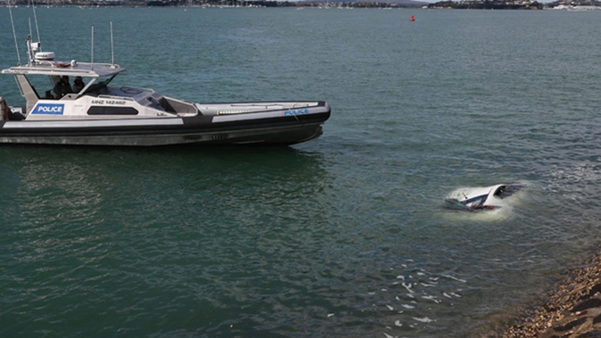 Police in attendance at the incident where a vehicle has gone into the harbour off Westhaven Drive in Auckland. Photo / Dean Purcell