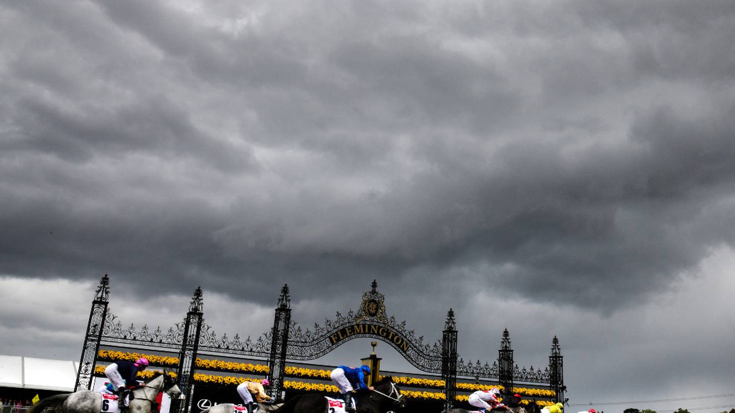 Dark clouds loom over Flemington Raceway. Photo / Getty