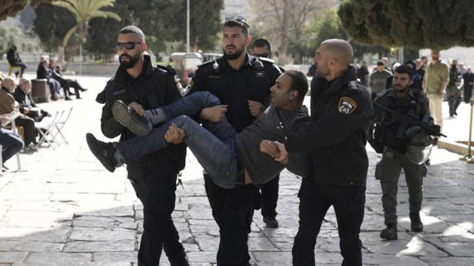 Israeli police detain a Palestinian in the Al-Aqsa Mosque compound after a raid of the site in the Old City of Jerusalem. Photo / AP